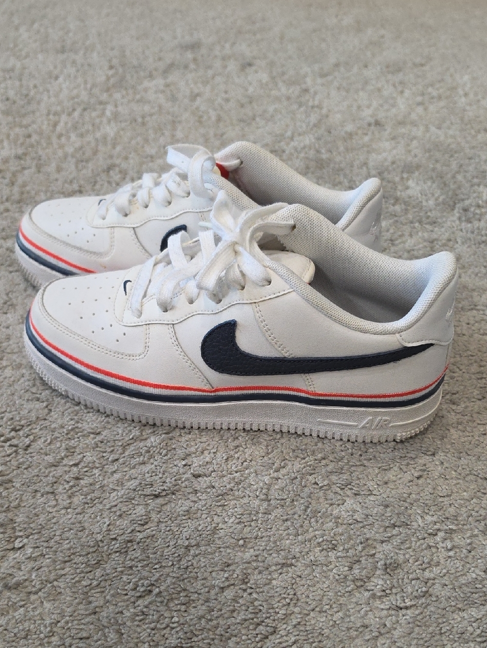 Nike Kids White Sneakers with Navy Swoosh and Red Stripe